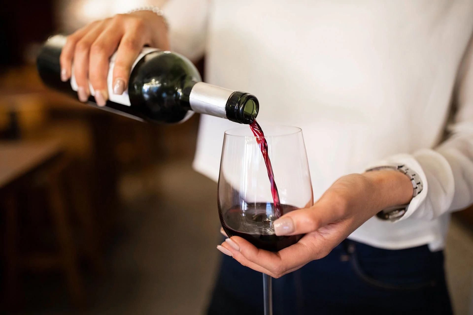 Spanish red wine being poured from the UNA wine menu